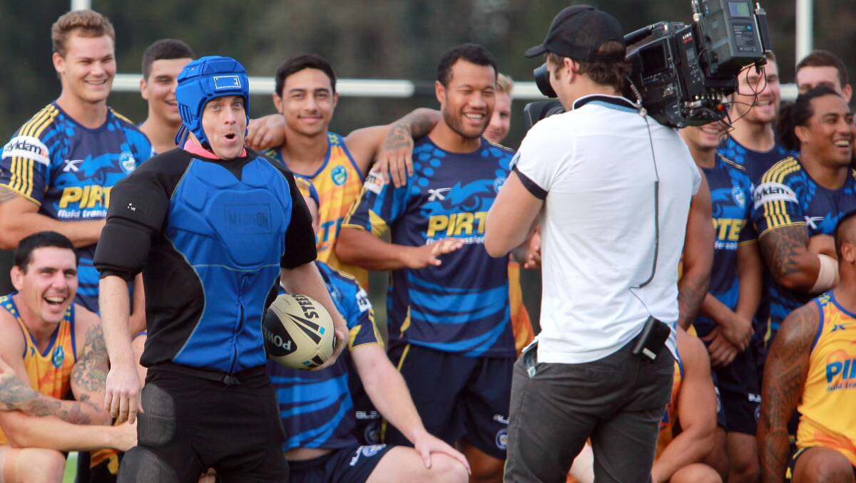 TACKLING THE WEATHER: Grant Denyer doing the weather from Eels training. Photo: Grant Robertson 010213GRA03