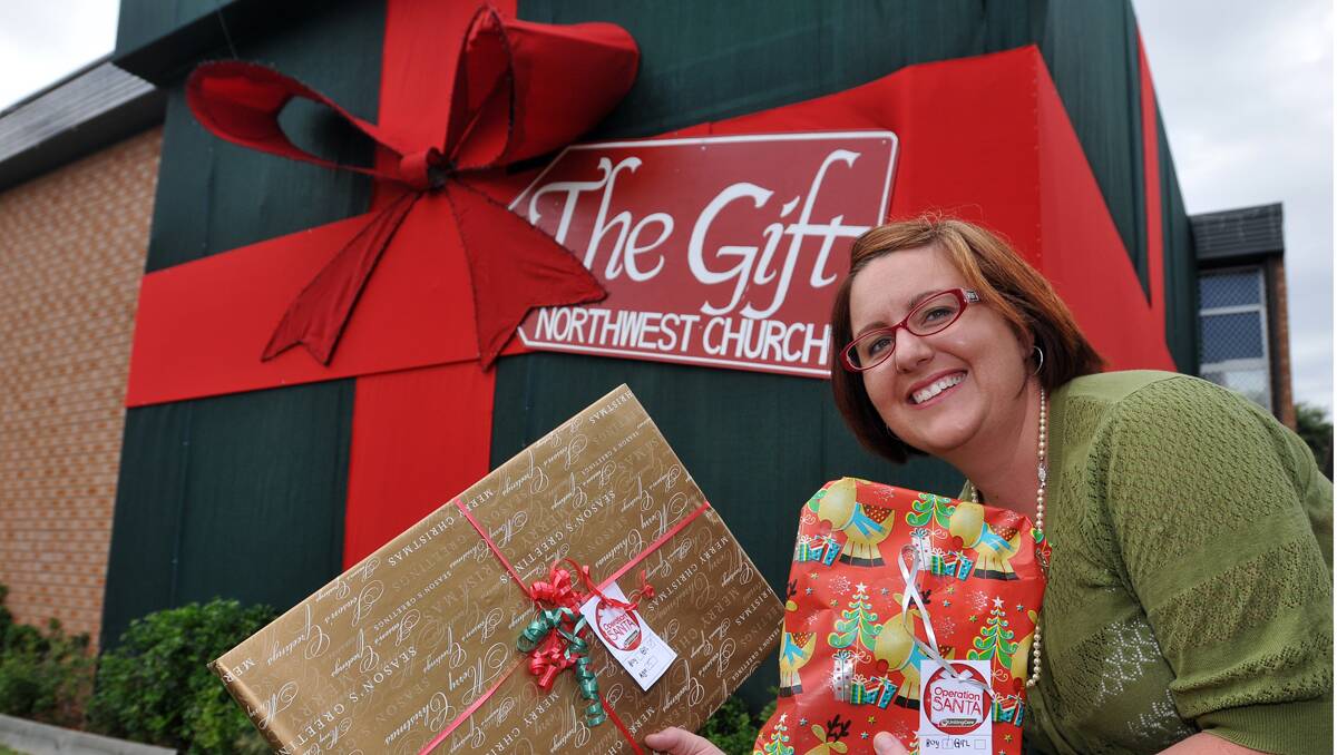 WRAPPED UP: Northwest Church’s wrapping is a reminder of the true gift of Chirstmas and to promote its Christmas production, The Gift, which is being produced by Marilyn Stebbings. Photo: Geoff O’Neill 101212GOC01