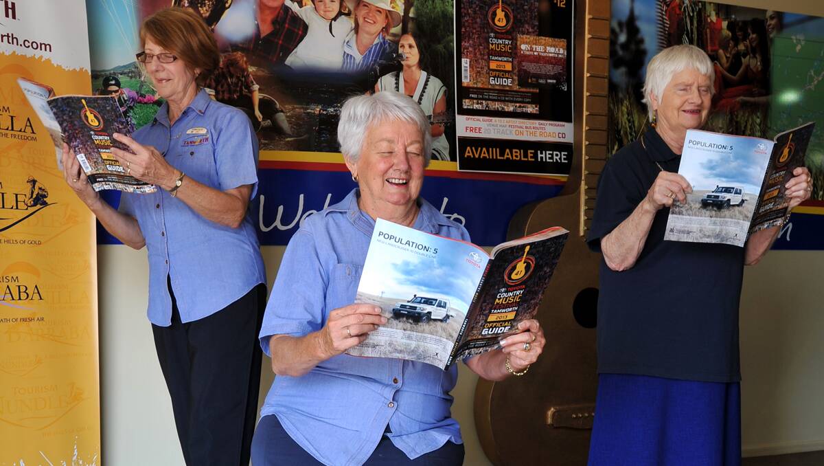 TALKING TURKEY:Tourism visitor guides Bev Cork, left, Mareen Bithrey and Wanda Campbell have been swotting up on all the info they will need for the Tamworth  Country Music Festival next month after the delivery of the latest official guide from Rural Press Events. Photo: Barry Smith 211212BSA06