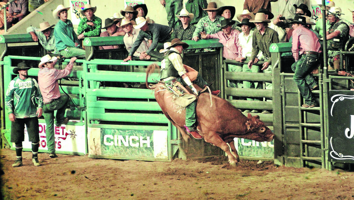 HANGING ON: Jamee Ovington from Gunnedah took this cracker of a bucking bull in action at the ABCRA finals at AELEC.