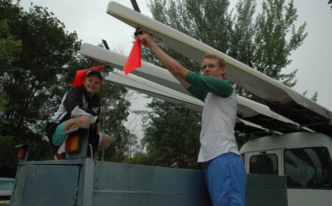 Coxswain Dan Lethbridge (left) and rower Lachlan Apps check the boats before departing for a four-day rowing camp on the Gold Coast.
