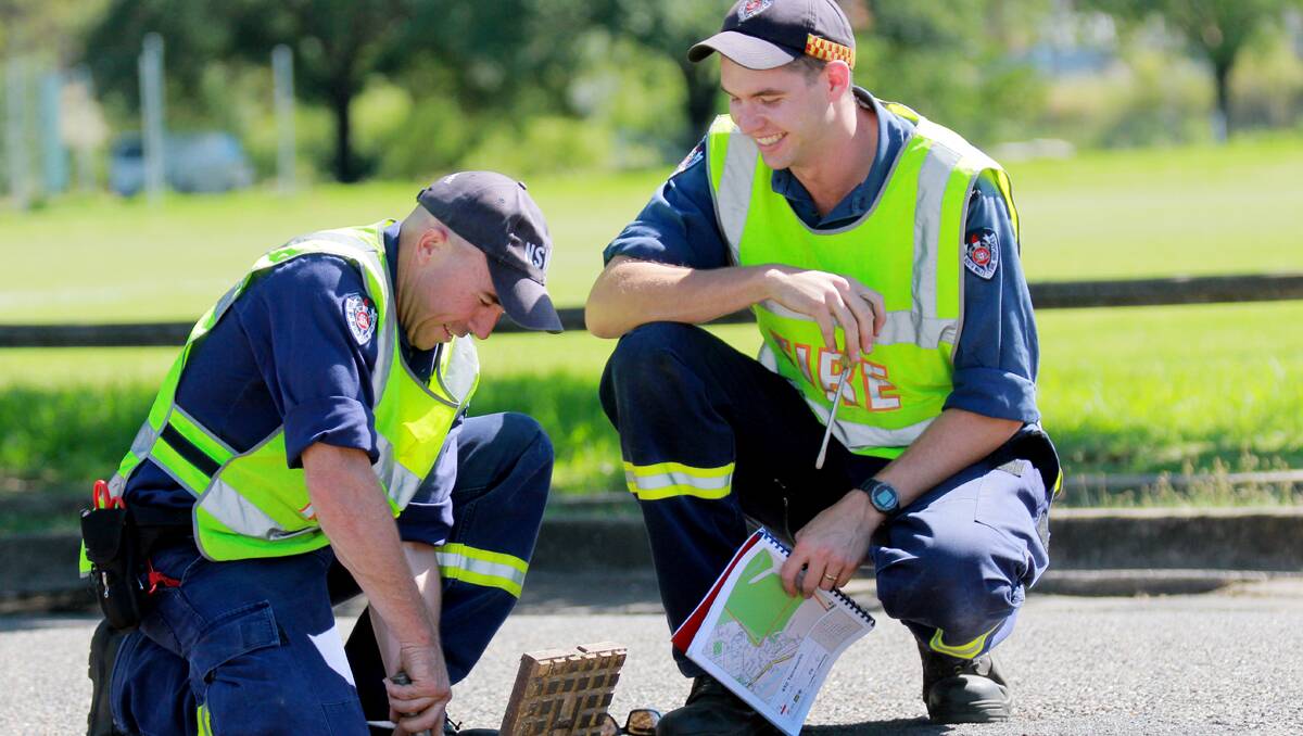 FINAL CHECKS: Tamworth Fire and Rescue firefighters Dan Murphy, left, and Joel Sim testing a roadside water hydrant in the Riverside camping grounds earlier this week. Photo: Robert Chappel 070113RCA125