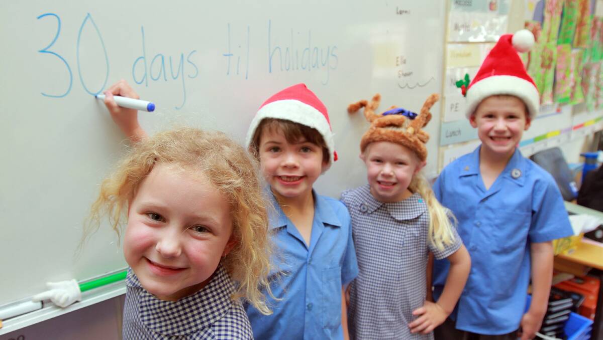 NOT LONG TO GO NOW: From left, Werris Creek Public School kindergarten students Erica Bizant, Blake Handsaker, Emily Daw and Darcy Lyon can’t wait for the school holidays to start. Photo: Robert Chappel 201112RCE06