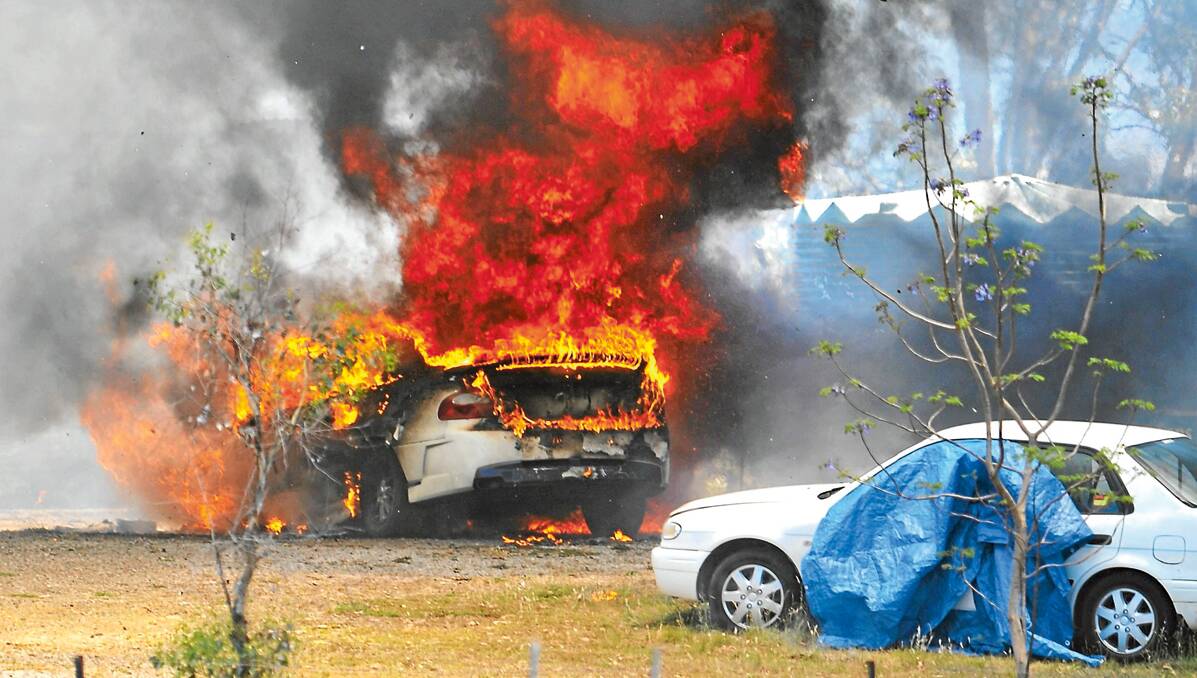 DESTROYED: A fire that gutted a home on the Oxley Highway yesterday afternoon also destroyed two nearby cars. Three people were taken to hospital with minor injuries. Photos: Barry Smith 121112BSA01