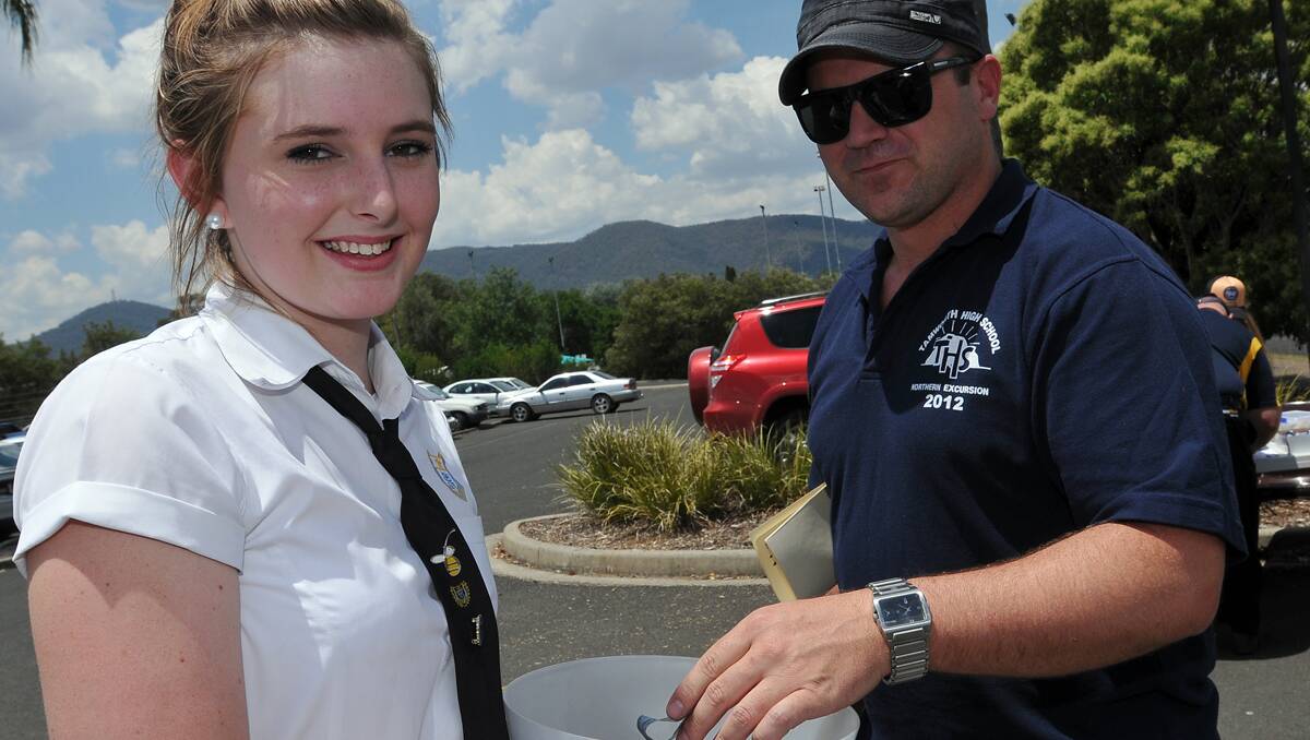 GOOD CAUSE: Tamworth High School student Jordan Rolfe collects a donation from teacher Michael Vereyken for the White Ribbon campaign.  Photo: Geoff O’Neill 231112GOC01