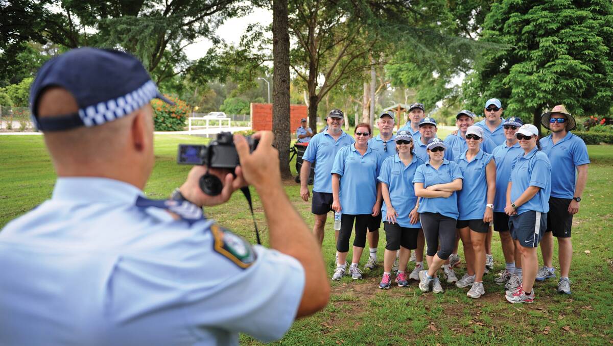 Police officer snaps the walkers for posterity in Maitland. Photo: Marina Neil