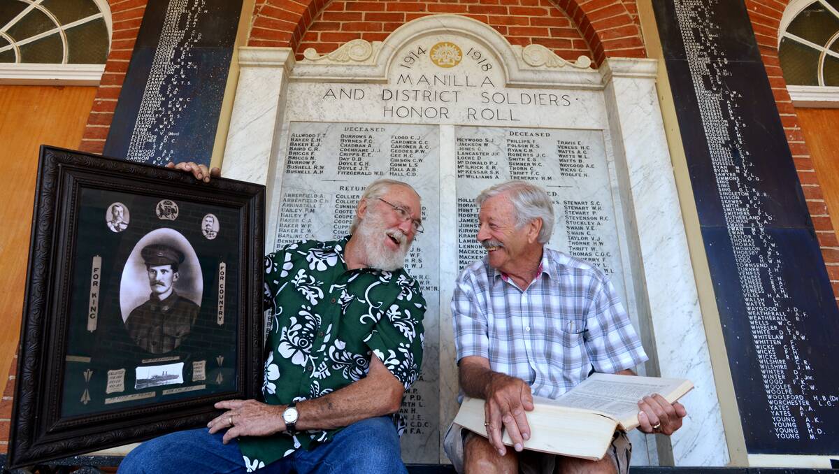 AN HONOURABLE TASK: Putting faces and stories to the Manilla Honour Roll has been a consuming passion for Manilla Historical Society president Ian Bignall, left, and military enthusiast and book coordinator Denis Creer. Photo: Barry Smith 020413BSC17