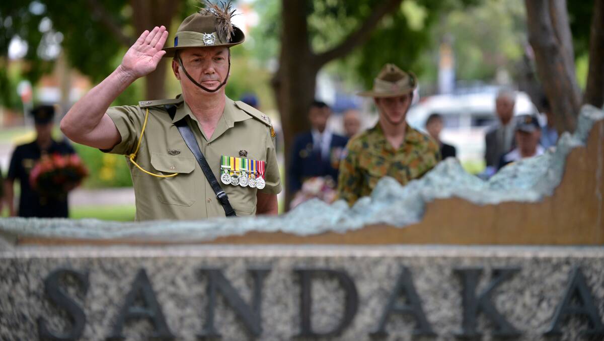 ALWAYS REMEMBERED: 12th/16th Hunter River Lancers operations officer Major Scott McRohan pays tribute to Sandakan victims. Photo: Barry Smith 150213BSF30