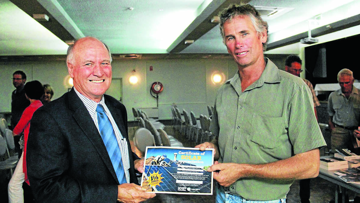 SYSTEMS POPULAR: Federal member for New England Tony Windsor, left, accepts the certificate of solar appreciation from Alistair Donaldson in Gunnedah.