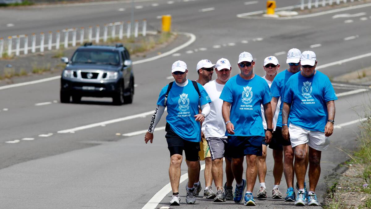 Walkers stretch out along a highway along the 370 km trek. Photo: Newcastle Herald