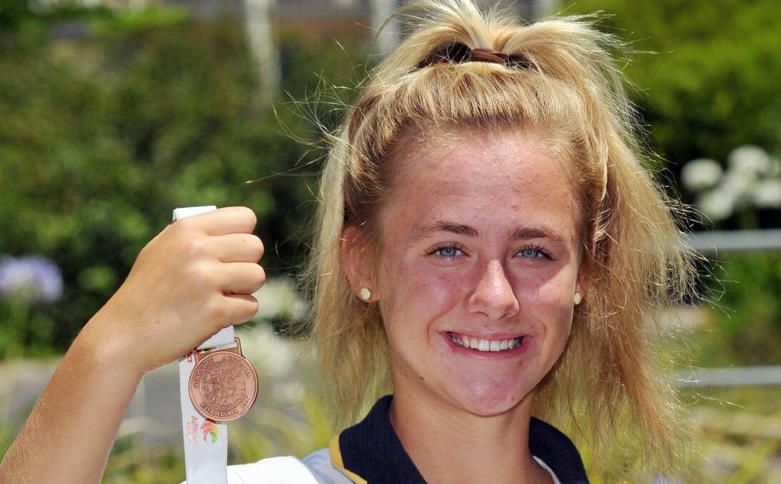 Ella Heeney shows off her Australian All Schools bronze medal she won in Townsville.  Photo: Geoff O’Neill 201213GOC01