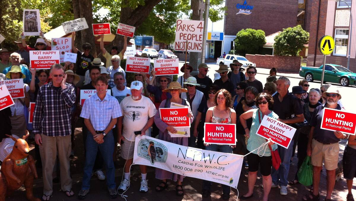 ‘NO HUNTING’: Some of the 150 people who rallied in Armidale’s Beardy St mall on Saturday to protest changes that could open up 78 national parks to shooters. 