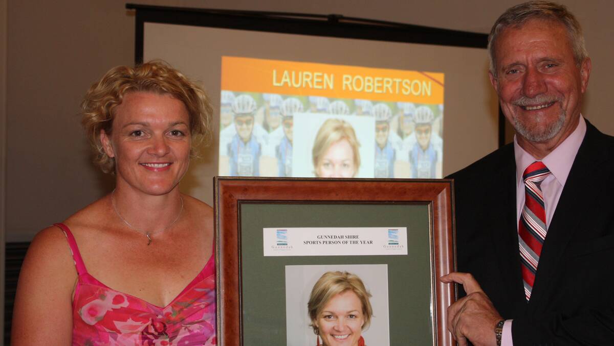 Lauren Robertson (left) receives her sportsperson of the year award from Gunnedah mayor Owen Hasler.