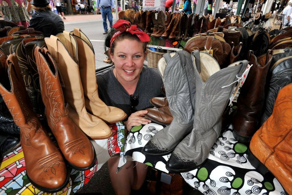 Emily Honess, the manager of Lifeline, puts her foot in it - in the best way - at the charity's vintage boot stand in Peel St.