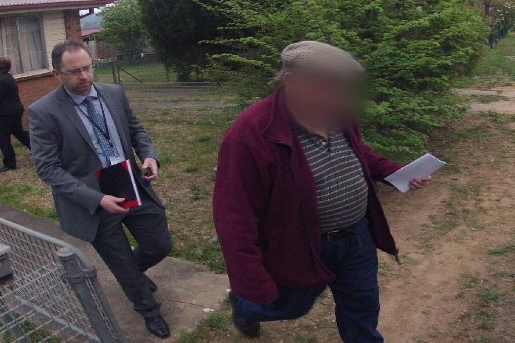 ARRESTED: The 59-year-old former priest is taken from his  Armidale home by police yesterday. He faces 25 charges relating to three girls aged between five and 18. Photo supplied by NSW Police media