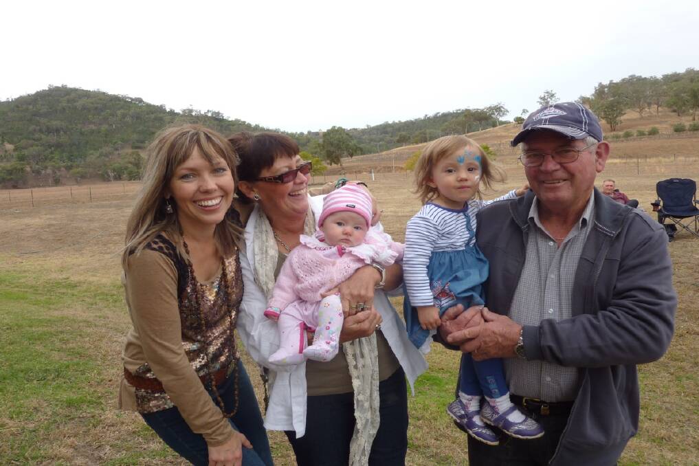 HOMECOMING: Felicity Urquhart, mum Trish holding Ellie, and dad Rex with Tia.  